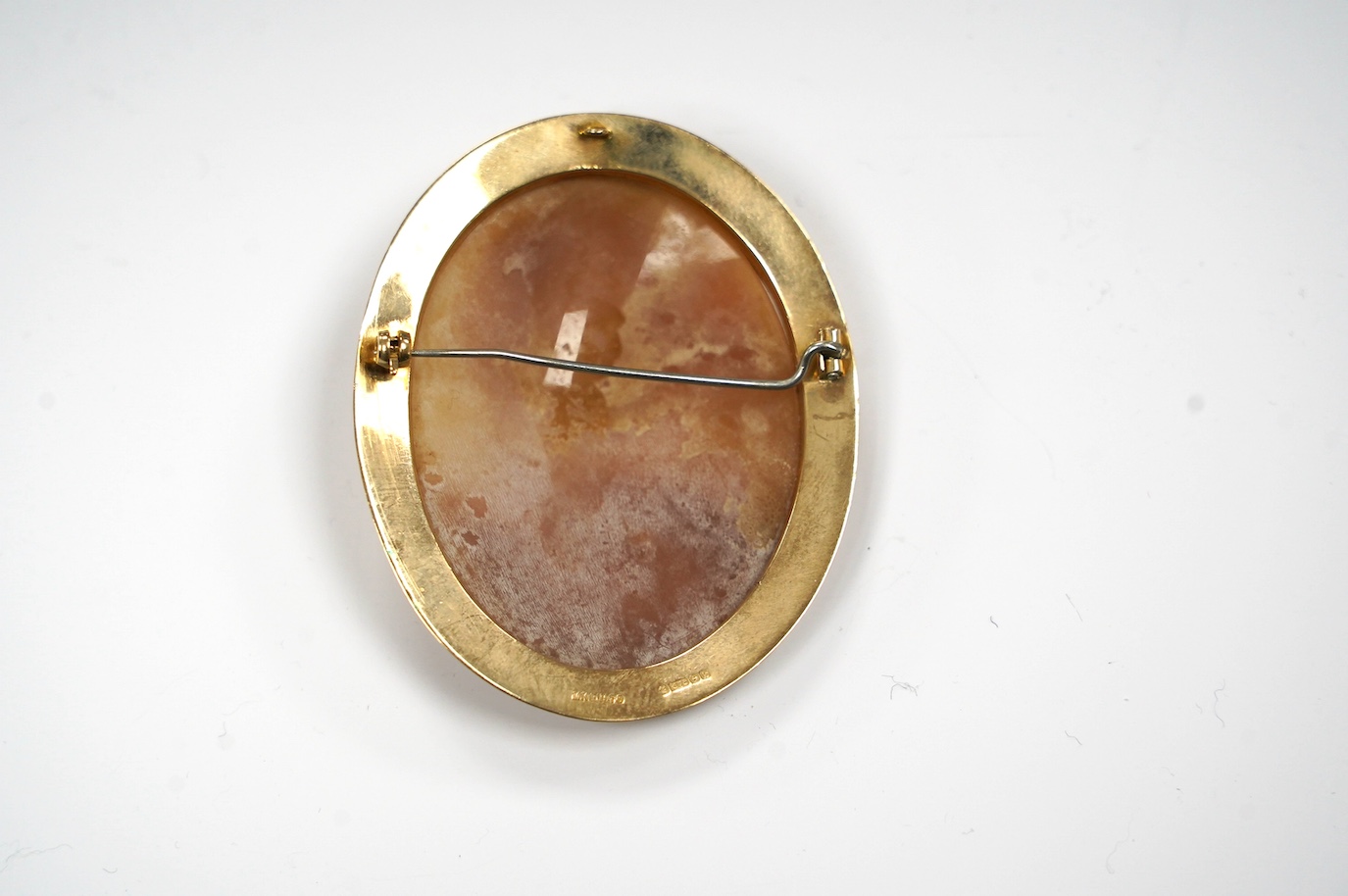 A modern engraved 9ct gold mounted oval cameo shell brooch, 59mm, gross weight 15.8 grams. Condition - fair